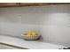 Close-up on a kitchen countertop featuring neutral tile backsplash and elegant stone countertops at 17 Winding Rd, Henderson, NV 89052