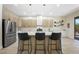 Kitchen island with seating and modern finishes is perfect for casual dining and entertaining at 17 Winding Rd, Henderson, NV 89052