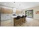 Open kitchen with large island, modern bar stools, and slider to the backyard at 17 Winding Rd, Henderson, NV 89052