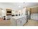 Spacious kitchen with stainless steel refrigerator, modern cabinets, and an eat-in marble island at 17 Winding Rd, Henderson, NV 89052