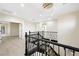 Upper landing with elegant railings, modern light fixture, and view of the staircase at 17 Winding Rd, Henderson, NV 89052