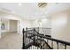 Open landing with wood floors, iron stair railing, and modern lighting at 17 Winding Rd, Henderson, NV 89052