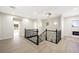 Open landing with wood floors, iron stair railing, and a modern chandelier at 17 Winding Rd, Henderson, NV 89052