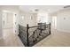 Bright upstairs landing with light hardwood floors, black railings, and modern lighting at 17 Winding Rd, Henderson, NV 89052