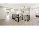 Spacious landing with hardwood floors, black iron railings, and an elegant modern light fixture at 17 Winding Rd, Henderson, NV 89052
