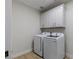 Laundry room featuring white cabinetry and washer and dryer units at 17 Winding Rd, Henderson, NV 89052