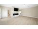 Open-concept living room featuring a modern fireplace, TV, and light hardwood floors at 17 Winding Rd, Henderson, NV 89052