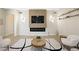 Living room area with a fireplace, mounted TV, and floating shelves at 17 Winding Rd, Henderson, NV 89052