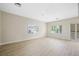 Light-filled living room featuring sliding doors, a ceiling fan, and hardwood floors at 17 Winding Rd, Henderson, NV 89052