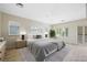 Staged main bedroom with neutral decor, ceiling fan, and patio access at 17 Winding Rd, Henderson, NV 89052
