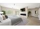 Main bedroom featuring a fireplace, tv, light floors and ceiling fan at 17 Winding Rd, Henderson, NV 89052