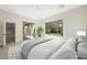 Bright main bedroom with ceiling fan, back yard views, and easy access to the backyard patio at 17 Winding Rd, Henderson, NV 89052