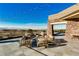 Outdoor seating on stone patio with desert and mountain views at 17 Winding Rd, Henderson, NV 89052