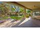 A covered patio with a spiral staircase, lush landscaping, and an outdoor seating area at 17 Winding Rd, Henderson, NV 89052