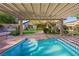 Backyard with a pool, patio cover, and beautifully landscaped yard at 17 Winding Rd, Henderson, NV 89052