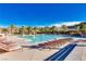 Resort style pool with lounge chairs and palm trees on a clear sunny day at 17 Winding Rd, Henderson, NV 89052