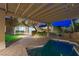 Backyard pool and pergola, illuminated at night, creates a serene oasis perfect for relaxation at 17 Winding Rd, Henderson, NV 89052