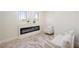 Cozy sitting area featuring a modern electric fireplace and neutral-toned furniture at 17 Winding Rd, Henderson, NV 89052