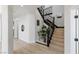 Elegant staircase features dark iron railings, decorative lighting, and modern wood floors at 17 Winding Rd, Henderson, NV 89052