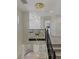 View of the staircase with a decorative chandelier and dark metal railing at 17 Winding Rd, Henderson, NV 89052