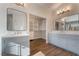 Elegant bathroom with double vanity, large mirrors, and separate walk-in closet at 2257 Loring Ave, Henderson, NV 89074