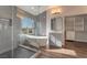 Modern bathroom with soaking tub, walk-in shower, and gray tile at 2257 Loring Ave, Henderson, NV 89074