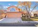 Two-story house with three-car garage and mature tree in front yard at 2257 Loring Ave, Henderson, NV 89074