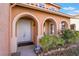 Elegant double front doors with arched entryway and landscaping at 2257 Loring Ave, Henderson, NV 89074