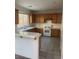 Traditional kitchen featuring tile counters, wood cabinets, and a breakfast bar at 6140 Natural Slope St, Las Vegas, NV 89148