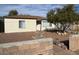 Ranch style home with landscaped front yard and block wall at 132 W Victory Rd, Henderson, NV 89015