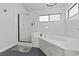 Spa-like bathroom with marble walls, a soaking tub, and a glass shower at 2761 Cape Hope Way, Las Vegas, NV 89121