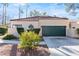 Front view of a single-story home with a green garage door at 2761 Cape Hope Way, Las Vegas, NV 89121