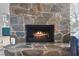 Cozy stone fireplace with a glowing fire, adding warmth to the room at 2761 Cape Hope Way, Las Vegas, NV 89121