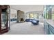 Living room with stone fireplace, large windows, and a curved sofa at 2761 Cape Hope Way, Las Vegas, NV 89121