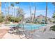 Community pool with lounge chairs and umbrellas at 2761 Cape Hope Way, Las Vegas, NV 89121