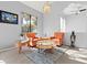 Sunlit sitting area furnished with two orange armchairs and a coffee table at 2761 Cape Hope Way, Las Vegas, NV 89121