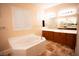 Bathroom with large tub, double vanity, and tiled floor at 9408 Forest Edge Ave, Las Vegas, NV 89149