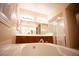 Elegant bathroom with double sinks, a large soaking tub, and a separate shower at 9408 Forest Edge Ave, Las Vegas, NV 89149