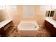 Spa-like bathroom with a large soaking tub and tile flooring at 9408 Forest Edge Ave, Las Vegas, NV 89149