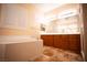 Spa-like bathroom with soaking tub and double vanity at 9408 Forest Edge Ave, Las Vegas, NV 89149