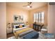 Bedroom with gray upholstered bed and bedside tables at 9408 Forest Edge Ave, Las Vegas, NV 89149