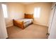 Bedroom with wooden bed frame and carpeted floor at 9408 Forest Edge Ave, Las Vegas, NV 89149