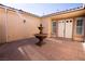 Courtyard entry with fountain and double doors at 9408 Forest Edge Ave, Las Vegas, NV 89149