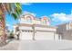 Charming two-story home features a three car garage, tile roof, and easy to maintain landscaping at 2196 Pescara Ct, Las Vegas, NV 89123