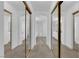 Bright hallway featuring white walls and multiple closets with mirrored doors at 2196 Pescara Ct, Las Vegas, NV 89123