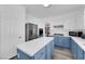 Bright eat-in kitchen features stainless steel appliances, blue cabinets, and island at 2196 Pescara Ct, Las Vegas, NV 89123