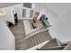 Aerial view of living room with staircase, white sofa, hardwood floors, pool table and open concept design at 2196 Pescara Ct, Las Vegas, NV 89123