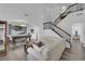 Bright and airy living room features hardwood floors, high ceilings, and a staircase with black railings at 2196 Pescara Ct, Las Vegas, NV 89123