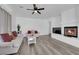 Cozy living room with a fireplace, white sofa, hardwood floors, and open concept design at 2196 Pescara Ct, Las Vegas, NV 89123