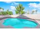 Backyard pool surrounded by low walls, landscaping and lush green trees at 2196 Pescara Ct, Las Vegas, NV 89123